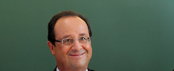 French President Francois Hollande sits for a discussion as he visits the school Michelet for the start of the school year, in Denain, northern France, Tuesday, Sept. 3, 2013. The board reads : Today, it is the start of school year" (AP Photo/ Denis Charlet, Pool)