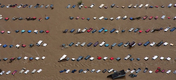 A field of parked cars and trucks sits partially submerged near Greeley, Colo., Saturday, Sept. 14, 2013, as debris-filled rivers flooded into towns and farms miles from the Rockies. Hundreds of roads, farms and businesses in the area have been damaged or destroyed by the floodwaters. (AP Photo/John Wark)