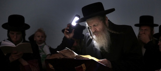 Ultra-Orthodox Jewish men participate in a Tashlich ceremony at the Mediterranean sea, in the southern Israeli port city of Ashdod, Thursday, Sept. 12, 2013. Tashlich, which means 'to cast away' in Hebrew, is the practice by which Jews go to a large flowing body of water and symbolically 'throw away' their sins by throwing a piece of bread, or similar food, into the water before the Jewish holiday of Yom Kippur, which start on Friday. (AP Photo/Tsafrir Abayov)