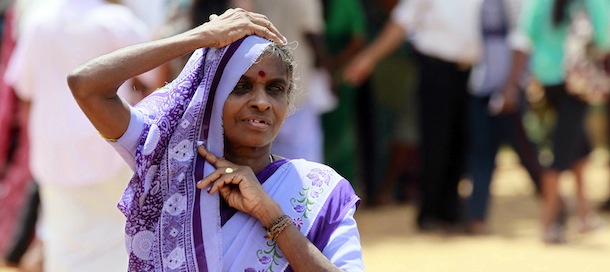 A Sri Lankan ethnic Tamil woman leaves a polling station after casting her vote during the northern provincial council election in Jaffna, Sri Lanka, Saturday, Sept. 21, 2013. The Tamils who are concentrated in the country's northern province are taking part in the election to form their first functioning provincial council, hoping that it will be first step toward winning wider self-government which they failed to achieve over the past 60 years, first through non-violent protests and strikes and later through a bloody quarter-century civil war. (AP Photo/Eranga Jayawardena)