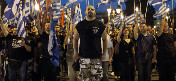 Members and supporters of the ultra-nationalist Golden Dawn party chant the national anthem in front of the Greek parliament in central Athens on May 29, 2013, during a rally marking the anniversary of the fall of Constantinople to the Ottoman Empire in 1453. The World Jewish Congress has criticised Greece's delay in adopting tougher anti-racism legislation aimed at curbing the extreme party Golden Dawn, owing to disagreement within the Greek government coalition. AFP PHOTO/ STR (Photo credit should read STR/AFP/Getty Images)
