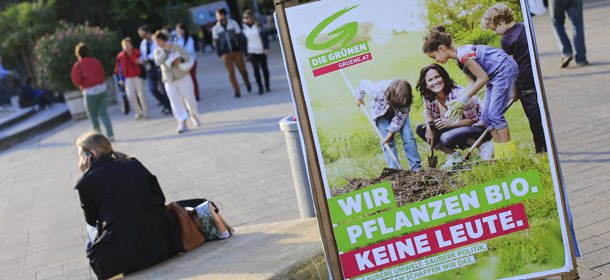 TO GO WITH AFP STORY BY THOMAS BACH
A woman sits next to a poster of the Austrian Green party (Die Gruenen) featuring Eva Glawischnig in Vienna on September 12, 2013, prior to legislative elections on September 29, 2013. AFP PHOTO / ALEXANDER KLEIN (Photo credit should read ALEXANDER KLEIN/AFP/Getty Images)
