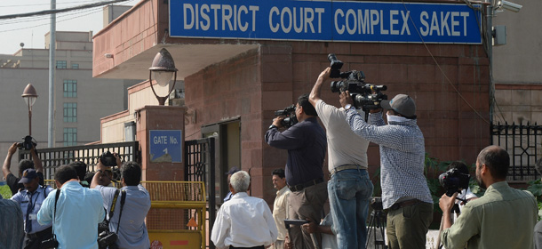 Photojournalists take pictures of a Delhi police van believed to be carrying the accused in a gangrape case as it enters Saket Court Complex in New Delhi on September 10, 2013. A judge is expected to hand down a verdict on four men accused of the fatal gang-rape of an Indian student on a bus, which could see the defendants sentenced to death. The parents of the popular physiotherapy student have been at the forefront of calls for the four to be hanged over the December 16 attack in New Delhi which triggered mass protests as well as new anti-rape laws. AFP PHOTO/ Prakash SINGH
 (Photo credit should read PRAKASH SINGH/AFP/Getty Images)