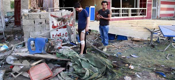 People inspect the site of a car bomb attack at the Karrada neighborhood of Baghdad, Iraq, Wednesday, Sept. 4, 2013. A series of coordinated evening blasts in Baghdad and other violence killed and wounded scores of people on Tuesday, officials said, the latest in a months-long surge of bloodshed that Iraqi security forces are struggling to contain. (AP Photo/Hadi Mizban)