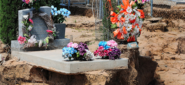 Numerous grave sites in the La Union Cemetery in La Union, N.M., are seen on Monday, Sept. 16, 2013. The graves were disturbed during the flood on Sept. 12. Some residents were worried after bones were spotted in town after the flood subsided, however the bones were determined to be animal bones, and mostly bovine according to officials. (AP PHOTO/Las Cruces Sun-News, Shari Vialpando-Hill)