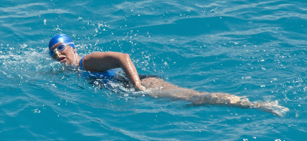 In this photo provided by the Florida Keys News Bureau, Diana Nyad, positioned about two miles off Key West, Fla., Monday, Sept. 2, 2013, swims towards the completion of her 111-mile trek from Cuba to the Florida Keys. Nyad, 64, is be first swimmer to cross the Florida Straits without the security of a shark cage. (AP Photo/Florida Keys Bureau, Andy Newman)