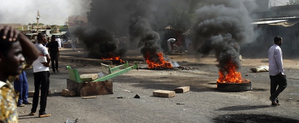 Protesters burn tires and close the highway to northern cities amid a wave of unrest over the lifting of fuel subsidies by the Sudanese government, in Kadro, 15 miles (24.14 kilometers) north of downtown Khartoum, Wednesday, Sept. 25, 2013. Sudan's loss of its main oil-producing territory with the independence of South Sudan in 2011 was a punch to its fragile economy. (AP Photo/Abd Raouf)