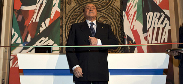 Former Italian Premier Silvio Berlusconi prepares to cut the ribbon to inaugurate the new headquarters of his "Forza Italia" (Go Italy) party, in Rome, Thursday, Sept. 19, 2013. Berlusconi inaugurated his party headquarters a day after a Senate committee refused to back a recommendation by one of his lawmakers that Berlusconi keep his Senate seat as a 2012 law bans anyone sentenced to more than two years in prison from holding or running for public office for six years. This summer Italy's top criminal court upheld Berlusconi's conviction and four-year sentence for tax fraud. The full Senate must eventually decide if he keeps is Senate seat. (AP Photo/Massimo Percossi, pool)