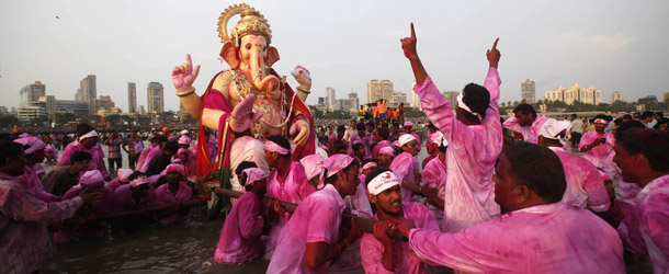 Devotees pull an idol of elephant-headed Hindu God Ganesha for immersion in the Arabian Sea in Mumbai, India, Wednesday, Sept. 18, 2013. The immersion marks the end of the ten-day long Ganesh Chaturthi festival that celebrates the birth of the Hindu God. (AP Photo/Rafiq Maqbool)