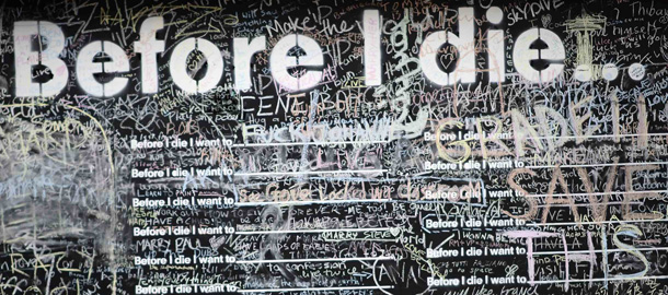 Graffiti is chalked onto a hoarding in front of a disused building in London. The hoarding asks "Before I die I want to_." leaving pedestrians to finish off the sentence. Picture taken September 24, 2013. REUTERS/Dylan Martinez (BRITAIN - Tags: ENTERTAINMENT SOCIETY) TEMPLATE OUT