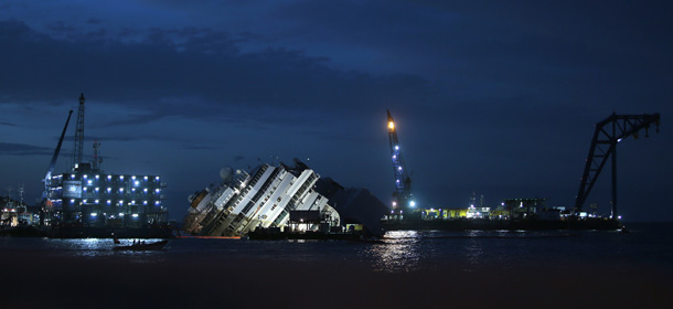 The capsized cruise liner Costa Concordia lies on its side next to Giglio Island. September 16, 2013. REUTERS/Tony Gentile (ITALY - Tags: DISASTER)