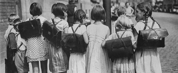 Schoolchildren on their way home from school, with book bags strapped on their backs, after the first day of a new term in Germany circa 1930. (Photo by Keystone View/FPG/Getty Images)