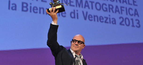 Italian director Gianfranco Rosi poses with the Golden Lion for Best Film he received for his movie "Sacro Gra" during the award ceremony of the 70th Venice Film Festival on September 7, 2013 at Venice Lido. AFP PHOTO / TIZIANA FABI (Photo credit should read TIZIANA FABI/AFP/Getty Images)