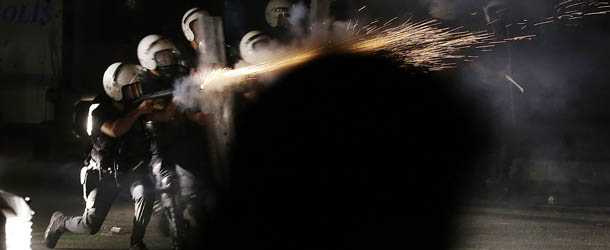 A Turkish policeman fires teargas during clashes which broke out to protest the death of Ahmet Atakan in Hatay, Turkey, Tuesday, Sept. 10, 2013. Atakan, 22 years old, died Monday night in Hatay after being hit in the head by a teargas canister shot by police during a an anti-government protest, the Atakan family have said.(AP Photo/Gregorio Borgia)