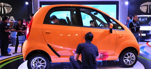 Workers wipe the low-cost Nano car manufactured by Tata of India, which owns British luxury brands Jaguar and Land Rover, during the 20th Indonesia International Motor Show 2012 in Jakarta on 22 September 2012. India's leading vehicle maker Tata Motors announced it had set up a wholly owned Jakarta-based subsidiary, PT Tata Motors Indonesia, to start selling vehicles next year. AFP PHOTO / Bay ISMOYO (Photo credit should read BAY ISMOYO/AFP/GettyImages)