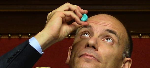 Italys' Prime Minister Enrico Letta puts eye drops prior to deliver a speech at the Senate in Rome on October 2, 2013 before today's confidence vote at the Parliament. Enrico Letta warned lawmakers ahead of a crucial vote of confidence today that the country ran a "fatal" risk as Silvio Berlusconi tries to topple his government. "Italy runs a risk that could be a fatal risk. Seizing this moment or not depends on us, on a yes or a no," Letta said in his address. AFP PHOTO / FILIPPO MONTEFORTE (Photo credit should read FILIPPO MONTEFORTE/AFP/Getty Images)