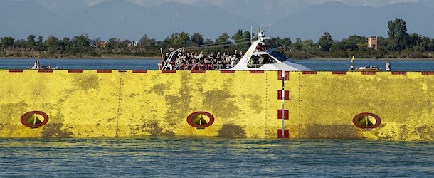 VENICE, ITALY - OCTOBER 12: Guests are seen on a boat behind three of the flood barrier gates of The MOSE that have been lifted for the first time on October 12, 2013 in Venice, Italy. The Mose project works towards protecting Venice from high tides and flooding. (Photo by Marco Secchi/Getty Images)