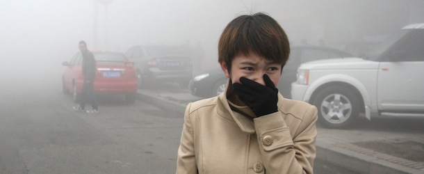 HARBIN, CHINA &#8211; OCTOBER 21: (CHINA OUT) A woman walks along a road as heavy fog engulfs the city on October 21, 2013 in Harbin, China. Heavy fog has been lingering in northeast China since Monday, disturbing the traffic, worsening air pollution and forcing the closure of schools. (Photo by ChinaFotoPress/ChinaFotoPress via Getty Images)
