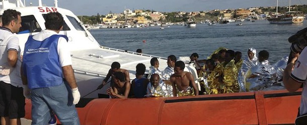 Rescued migrants arrive onboard a coastguard vessel at the harbour of Lampedusa 
October 3, 2013. An estimated 500 passengers on a boat that sank off the Sicilian island of Lampedusa on Thursday were all believed to be Eritreans coming from Libya, the U.N. High Commissioner for Refugees and the International Organization for Migration said. At least 82 people died and scores were missing, officials and rescuers said. REUTERS/Nino Randazzo/ASP press office/Handout via Reuters (ITALY - Tags: DISASTER SOCIETY IMMIGRATION POLITICS) ATTENTION EDITORS - THIS IMAGE WAS PROVIDED BY A THIRD PARTY. FOR EDITORIAL USE ONLY. NOT FOR SALE FOR MARKETING OR ADVERTISING CAMPAIGNS. THIS PICTURE IS DISTRIBUTED EXACTLY AS RECEIVED BY REUTERS, AS A SERVICE TO CLIENTS. NO SALES. NO ARCHIVES. MANDATORY CREDIT