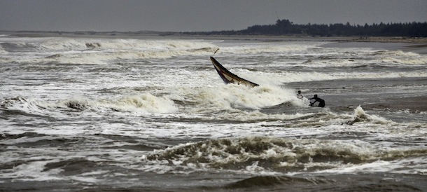 Indian fishermen try to balance their boat as they pull it out from the Bay of Bengal at Gokhurkuda in Ganjam district 215 kilometers (136 miles) away from the eastern Indian city of Bhubaneswar, India, Friday, Oct. 11, 2013. The Indian Meteorological Department warned that a massive cyclone Phailin was a "very severe cyclonic storm" that was expected to hit India’s eastern seaboard with maximum sustained winds of 210-220 kilometers (130-135 miles) per hour. (AP Photo/Biswaranjan Rout)