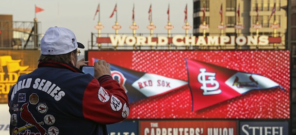 John Koenig takes a photo as players warm up for Game 5 of baseball&#8217;s World Series between the Boston Red Sox and the St. Louis Cardinals Monday, Oct. 28, 2013, in St. Louis. (AP Photo/Charlie Riedel)
