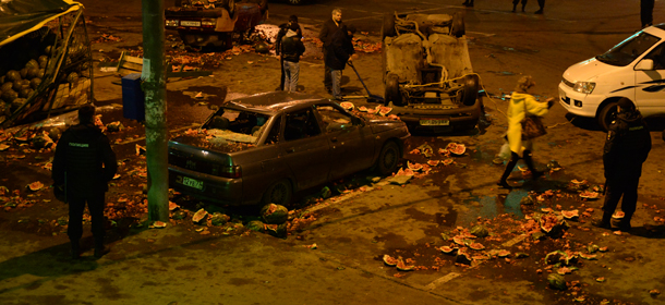 Police officers guard a vandalised street, the site of mass rioting in the southern Biryulyovo district of Moscow, late on October 13, 2013. Mass rioting broken out today in a southern Moscow district after a mixed crowd of nationalists and locals attacked a warehouse run by migrants and natives of the Caucasus. The riot was prompted by the fatal stabbing of an ethnic Russian in the area. AFP PHOTO / VASILY MAXIMOV (Photo credit should read VASILY MAXIMOV/AFP/Getty Images)
