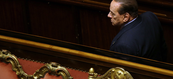 People of Freedom party leader Silvio Berlusconi passes past the Government and Presidency seat giving his yes vote on the occasion of a confidence vote at the Senate, in Rome, Wednesday, Oct. 2, 2013. Silvio Berlusconi acknowledged defeat Wednesday and announced he would support the government of Premier Enrico Letta, a stunning about-face on the Senate floor after defections in his party robbed him of the support he needed to bring down the government. (AP Photo/Gregorio Borgia)