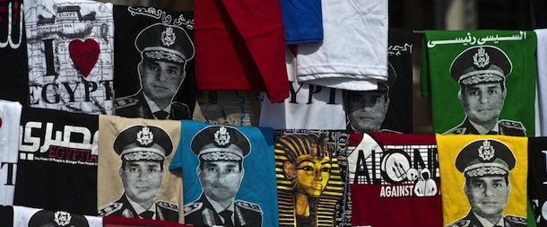 Shirts, some depicting Abdel Fattah al-Sisi, is displayed for sale on Tahrir Square during a gathering marking the 40th anniversary of the 1973 Arab-Israeli war on October 6, 2013 in the Egyptian capital Cairo. Egypt braced for rival demonstrations called by supporters and opponents of deposed Islamist president Mohamed Morsi during the anniversary&#8217;s festivities. AFP PHOTO / KHALED DESOUKI (Photo credit should read KHALED DESOUKI/AFP/Getty Images)

