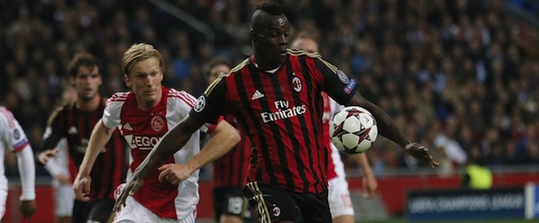 AC Milan's Mario Balotelli, right, is challenged by Ajax's Christian Poulsen during the Champions League Group H match Ajax against AC Milan at ArenA stadium in Amsterdam, Netherlands, Tuesday Oct. 1, 2013 (AP Photo/Peter Dejong)