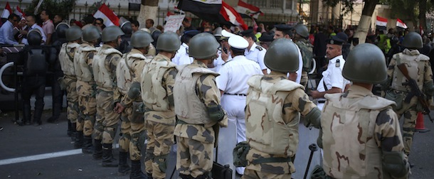 Egyptian army soldiers stand guard at an entrance to Tahrir Square, in Cairo, Egypt, Sunday, Oct. 6, 2013. Egyptian jetfighters staged celebratory flights over Cairo on Sunday, ushering in a commemoration of the 40th anniversary of the nation's last war with Israel on a day when rival rallies by supporters and opponents of the ousted Islamist president carry the potential for violence. (AP Photo/Khalil Hamra)