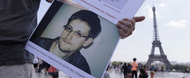 A demonstrator holds up a picture of former technical contractor of the US Central Intelligence Agency Edward Snowden reading &#8220;Stand up for whistleblowers and citizen rights!&#8221; as people gather at the Place du Trocadero in Paris during a demonstration in support of Snowden on July 7, 2013. Around forty people, mostly activists from organizations defending rights and freedom on the internet gathered in support of Snowden, who leaked information on data spying programs of the USA and Great Britain in June 2013 and has sought asylum in 21 countries, according to WikiLeaks. AFP PHOTO / KENZO TRIBOUILLARD (Photo credit should read KENZO TRIBOUILLARD/AFP/Getty Images)
