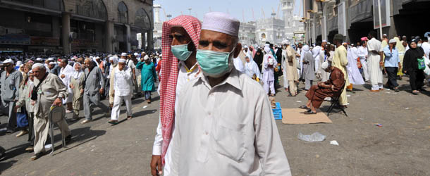 Muslim pilgrims wearing a mask leave after the Friday prayer at Mecca's Grand Mosque, on October 11, 2013 as hundreds of thousands of Muslims have poured into the holy city of Mecca for the annual hajj pilgrimage. The hajj is one of the five pillars of Islam and is mandatory once in a lifetime for all Muslims provided they are physically fit and financially capable. AFP PHOTO/FAYEZ NURELDINE (Photo credit should read FAYEZ NURELDINE/AFP/Getty Images)