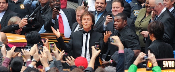 Paul McCartney arrives with his band to give a surprise pop up concert in Times Square on Thursday, Oct. 10, 2013 in New York. McCartney will release his new album called "New" on October 15. (Photo by Evan Agostini/Invision/AP)