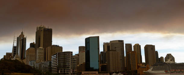 Smoke and ash from wildfires burning across the state of New South Wales blankets the Sydney city skyline on October 17, 2013. Seven major blazes were burning across the state, fanned by high, erratic winds in unseasonably warm 34 Celsius (93 Fahrenheit) weather, with infernos at Springwood and Lithgow in the Blue Mountains west of Sydney sending thick plumes of smoke and ash across the city. AFP PHOTO / Greg WOOD (Photo credit should read GREG WOOD/AFP/Getty Images)

