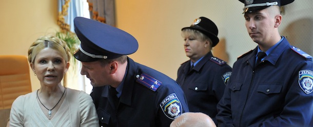 A picture taken on October 11, 2011 shows a police officer speaking to former Ukrainian Prime Minister Yulia Tymoshenko (L) after the Kiev Pechersky court rendered its verdict on her case. Ukraine&#8217;s former prime minister Yulia Tymoshenko on October 24, 2011 lodged an appeal against her conviction and seven year jail sentence for abusing her powers in a 2009 gas deal signed with Russia, her lawyer said. Tymoshenko personally made the appeal through the management of the Lukyankovsky detention centre in Kiev where she is being held, her lawyer Sergiy Vlasenko said according to the Interfax-Ukraine news agency. AFP PHOTO / SERGEI SUPINSKY (Photo credit should read SERGEI SUPINSKY/AFP/Getty Images)

