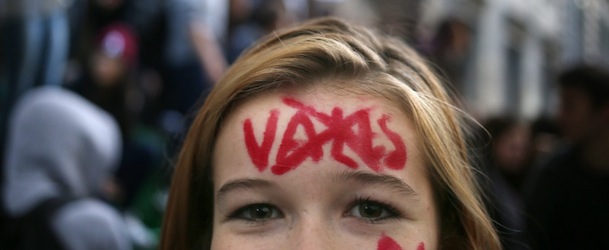 A student has written and crossed the name of France&#8217;s Interior Minister Manuel Valls as she demonstrates with other students in front of Turgot high school in Paris, on October 17, 2013, to protest against the expulsion of foreign students, after the expulsion to Kosovo of the media schoolgirl Leonarda, given to the police during a school trip. The minister has defended the treatment of the girl, amid an outcry within the ruling party. AFP PHOTO KENZO TRIBOUILLARD
