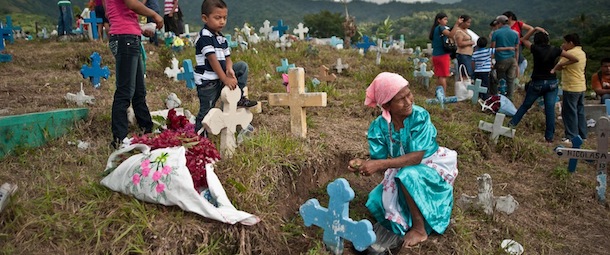Families visit tombs at a cemetery in Panchimalco, 18 kms south of San Salvador, on November 2, 2013 during the commemoration of the day of the dead. The traditional catholic holiday honors the dead and is celebrated annually. AFP PHOTO/ Jose CABEZAS (Photo credit should read Jose CABEZAS/AFP/Getty Images)
