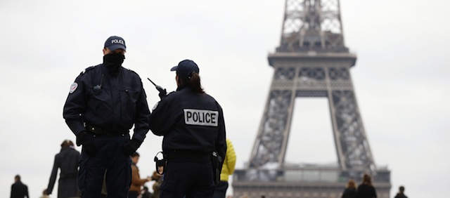 Police officers patrol at the Trocadero Esplanade (also named Human rights Esplanade) in front of the Eiffel Tower on November 18, 2013 in Paris, while a frantic manhunt is underway after a 27-year-old fought for his life after being shot at the Paris offices of French daily Liberation and the shooter fled the scene. Just over an hour later, witnesses described shots being fired outside the headquarters of Societe Generale bank in the La Defense business district. Police is also checking a statement by a car driver who claimed to have been taken hostage by a gunman near La Defense and forced to drop him off close to the Champs-Elysees. Police could not immediately confirm a link between all of today's reported incidents but said that CCTV images of the shooter suggested he was the same man who had stormed into the Paris headquarters of news channel BFMTV three days earlier. AFP PHOTO / THOMAS SAMSON (Photo credit should read THOMAS SAMSON/AFP/Getty Images)