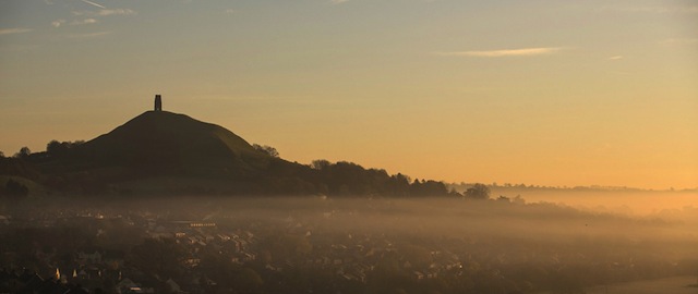 GLASTONBURY, UNITED KINGDOM - NOVEMBER 26: Mist lingers around Glastonbury Tor as the early morning sun rises on November 26, 2013 in Glastonbury, England. After a later than normal autumn and as the UK heads towards the meteorological winter, which spans the entirety of December, January, and February, weather forecasters are predicting a drop in temperatures, with more wintry weather due with a mix of fog, overnight frost, some scattered showers, as well as some sunny spells. (Photo by Matt Cardy/Getty Images)