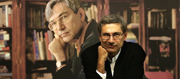 FRANKFURT/MAIN, Germany: Turkish novellist Orhan Pamuk poses in front of a poster showing himself 22 October 2005 during Frankfurt&#8217;s international Book fair, one day before receiving the Peace Prize of the German Book Trade. The widely translated author of internationally renowned works as &#8220;My Name Is Red&#8221; and &#8220;Snow,&#8221; is set to appear before court on December 16 on charges of denigrating Turkish national identity by telling a Swiss newspaper that &#8220;one million Armenians and 30,000 Kurds were killed in these lands and nobody but me dares to talk about it.&#8221; He risks a prison term of between six months and three years. AFP PHOTO DDP/TORSTEN SILZ GERMANY OUT (Photo credit should read TORSTEN SILZ/AFP/Getty Images)
