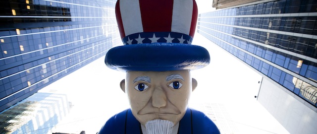 A giant Uncle Sam balloon is marched down 6th Avenue during the 87th Annual Macy's Thanksgiving Day Parade, Thursday, Nov. 28, 2013, in New York. After fears the balloons could be grounded if sustained winds exceeded 23 mph, Snoopy, Spider-Man and the rest of the iconic balloons received the all-clear from the New York Police Department to fly between Manhattan skyscrapers on Thursday. (AP Photo/John Minchillo)