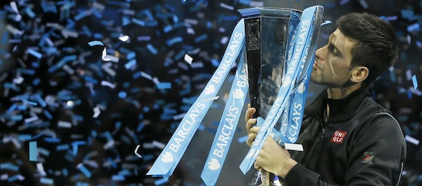Novak Djokovic of Serbia kisses the ATP World Tour Finals tennis trophy as he poses for photographers after defeating Rafael Nadal of Spain at the O2 Arena in London, Monday, Nov. 11, 2013. (AP Photo/Kirsty Wigglesworth)
