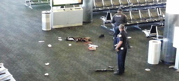 In this photo provided to the AP, which has been authenticated based on its contents and other AP reporting, police officers stand near an unidentified weapon in Terminal 3 of the Los Angeles International Airport on Friday, Nov. 1, 2013. Officials said a gunman who opened fire in the terminal was wounded in a shootout with police and taken into custody. (AP Photo)
