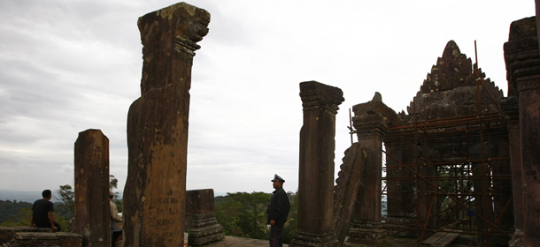 A temple guard stands guard at the famed Preah Vihear temple near Cambodia-Thai border in Preah Vihear Province, Cambodia, Sunday, Nov. 10, 2013. The International Court of Justice rules on a dispute between Cambodia and Thailand over land surrounding the 1,000-year-old temple on Monday.(AP Photo/Heng Sinith)
