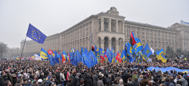 People hold a giant EU flag on November 24, 2013 during a rally in Kiev. Pro-West Ukrainians on November 24 staged the biggest protest in Kiev since the 2004 Orange Revolution, demanding that the government sign a key pact with the European Union and clashing with police. The opposition called the rally after President Viktor Yanukovych's government reversed a plan to sign a historic deal deepening ties with the European Union, in a U-turn critics said was forced by the Kremlin. Placard reads: "To Europe Without Yanukovych". AFP PHOTO/SERGEI SUPINSKY (Photo credit should read SERGEI SUPINSKY/AFP/Getty Images)