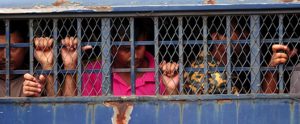 Bangladesh Border Guard soldiers on trial wait in a prison van at at the BDR headquarters in Dhaka on August 28, 2012. A special court is delivering verdict against 673 members of the 44th battalion for their alleged role in the 2009 bloody mutiny at the then Bangladesh Rifles headquarters. AFP PHOTO/Munir uz ZAMAN (Photo credit should read MUNIR UZ ZAMAN/AFP/GettyImages)
