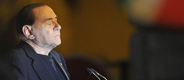 Italy's former Prime Minister Silvio Berlusconi delivers a speech outside his private residence, the Palazzo Grazioli, on November 27, 2013 in Rome. Italy's parliament prepared to expel Silvio Berlusconi today over his tax fraud conviction in a momentous move that raises the risk of his arrest but is unlikely to end his tumultuous career. Thousands of Berlusconi loyalists massed outside the three-time former prime minister's luxury home in Rome to support their leader, as lawmakers from his party took the floor of the Senate one by one to back him. AFP PHOTO / TIZIANA FABI (Photo credit should read TIZIANA FABI/AFP/Getty Images)