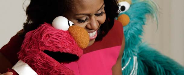 WASHINGTON, DC &#8211; OCTOBER 30: U.S. first lady Michelle Obama joins with Sesame Street&#8217;s Elmo (L) and Rosalita (R) for an announcement on a new initiative aimed at promoting healthier nutrition for school children Ocotber 30, 2013 in Washington, DC. During the event the first lady announced that Sesame Street characters will join with the Partnership for a Healthier America in a two-year agreement to promote greater fresh fruit and vegetable consumption by children. (Photo by Win McNamee/Getty Images)
