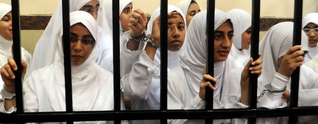 Female members of the Muslim Brotherhood are seen during their trial in the Egyptian city of Alexandria on November 27, 2013. A court in the Mediterranean city sentenced 14 women who it said were from the Brotherhood after convicting them of belonging to a "terrorist organisation," judicial sources said. AFP PHOTO/STR (Photo credit should read -/AFP/Getty Images)