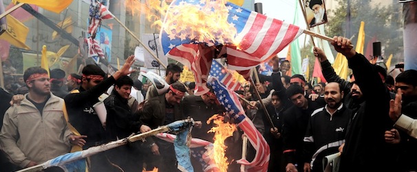 Iranians burn US flags outside the former US embassy in Tehran on November 4, 2013, during a demonstration to mark the 34th anniversary of the 1979 US embassy takeover. Thousands of Iranians shouted &#8220;Death to America&#8221; as they demonstrated 34 years after Islamist students stormed the embassy compound in Tehran, holding 52 American diplomats hostage for 444 days. AFP PHOTO/STR (Photo credit should read -/AFP/Getty Images)
